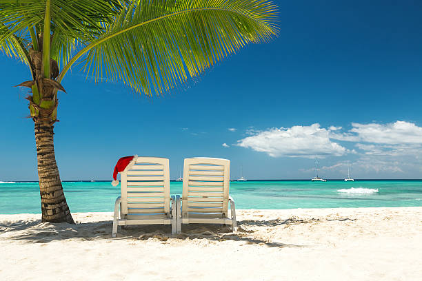 istock Santa's hat and sun loungers on the tropical beach 498097342