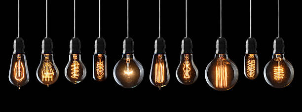 vintage light bulbs Set of vintage glowing light bulbs on black background tungsten metal stock pictures, royalty-free photos & images