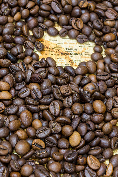 istock Map of Papua New Guinea under a coffee beans background 498097998