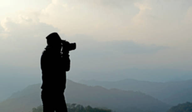 istock blurry silhouette photographer is taking photos 498098114