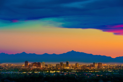 Phoenix Arizona skyline under a dramatic sunset as seen from Scottsdale