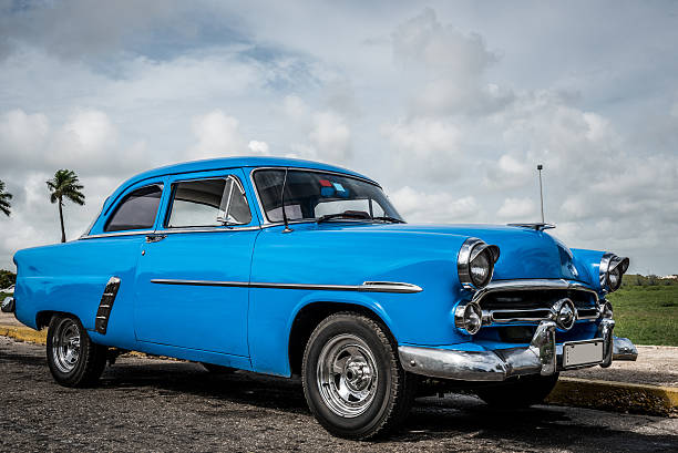 istock HDR blue american classic car with palms in Cuba 498100078