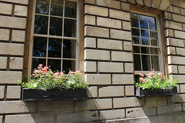 istock Window boxes with flowers on Georgian house, Bath stone bricks 498101189