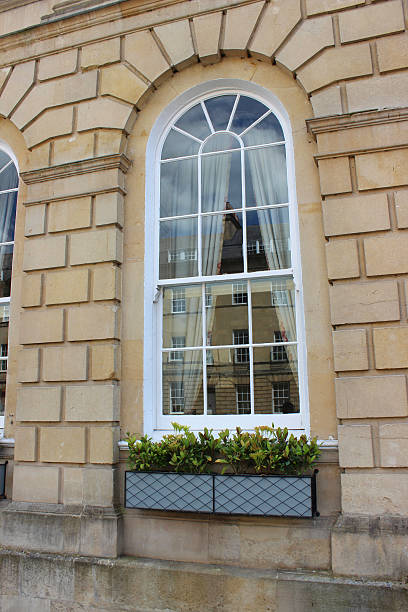 istock Window box with small evergreen shrubs on Georgian house windowsill 498101359