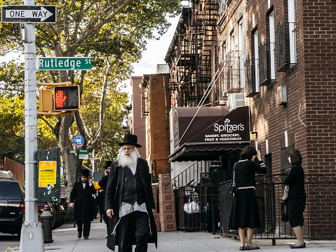 New York, USA - September 22, 2015: Jewish hassidic man crosses the street.