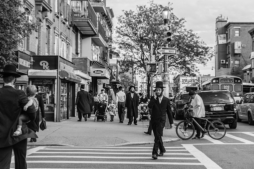 New York, USA - September 22, 2015: Jewish hassidic men cross the street.