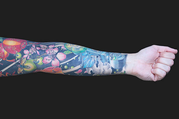 Tattoed Arm Tattoed Arm tattoo arm stock pictures, royalty-free photos & images