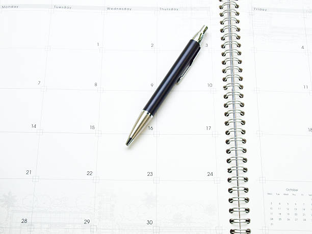 istock Calendar page in organizer and a pen as background 498102913