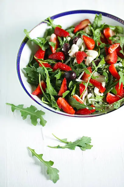 Photo of Rocket salad with strawberries, kalamata olives and goat cheese
