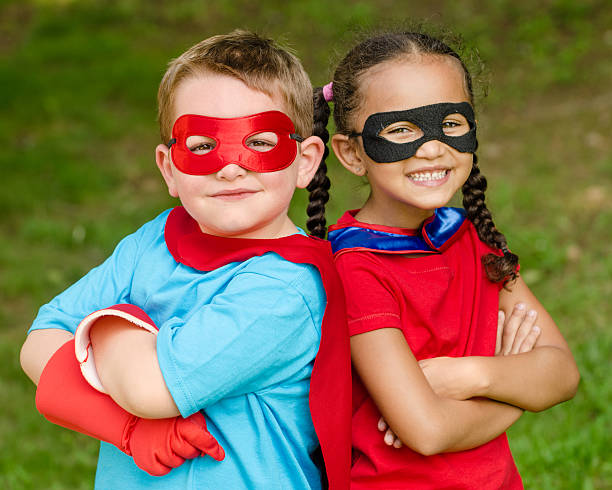 Children pretending to be superheroes stock photo