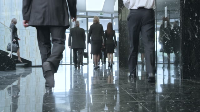 LD Business people walking through a lobby and out of the building
