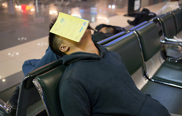 istock Tired man sleeping on the bench in the airport 498111374