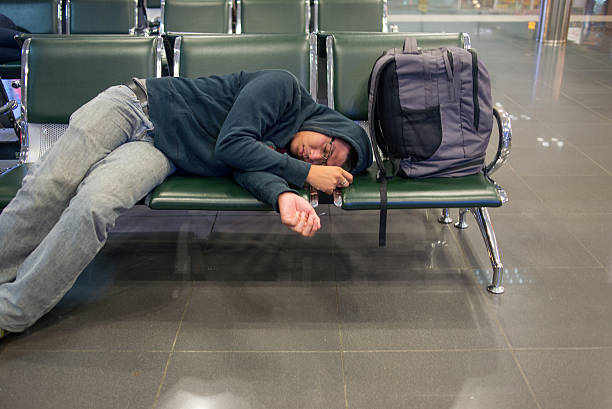istock The man oversleep on bench after a long flight 498112396
