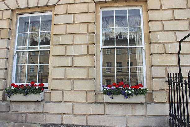 istock Window boxes with red Geranium flowers (pelargoniums) on Georgian house 498112571