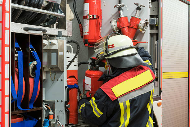 istock Firefighter gets a fire extinguisher from the fire truck 498112632
