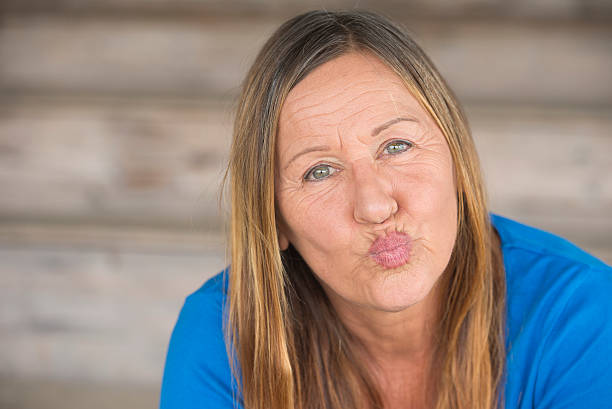 istock Portrait happy woman pursed lips 498112662