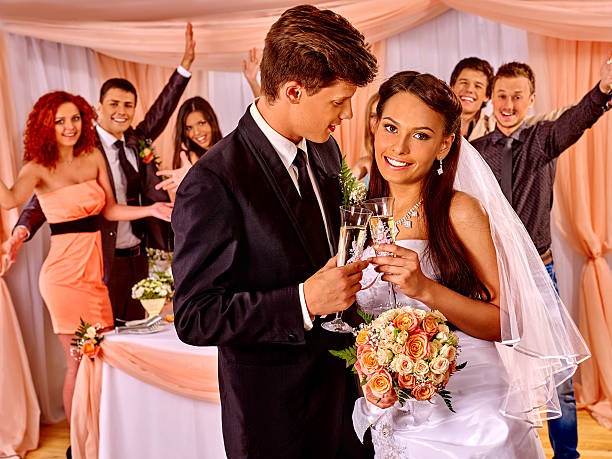 istock Wedding couple and guests drinking champagne 498112972