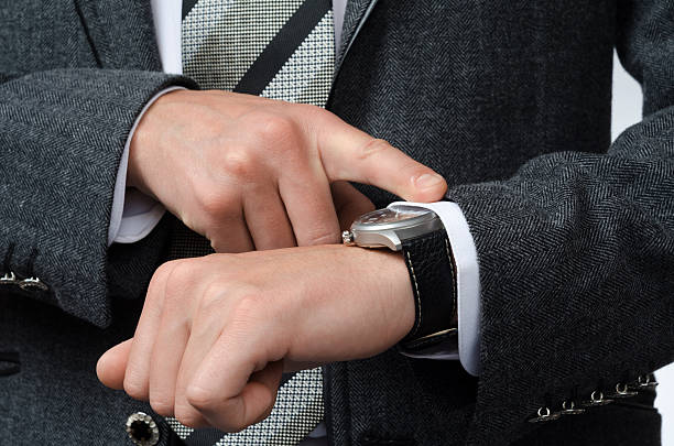 istock businessman watching time at their wristwatches 498113004