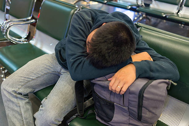 istock Drowsy man drooping head on backpack to have a nap 498113112