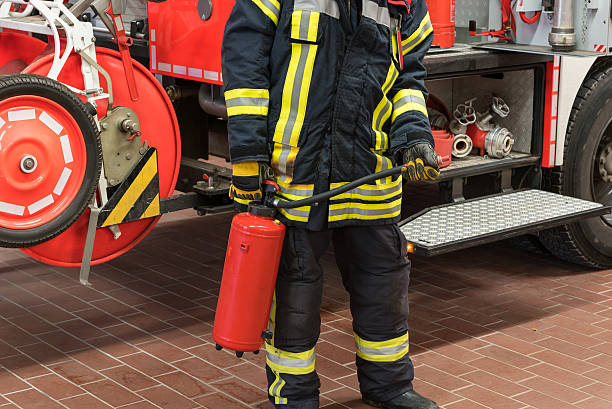istock Firefighter in action with a fire extinguisher 498113126