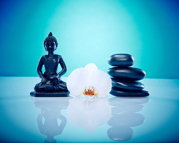 istock Buddah with hot stones and white orchis 498113919