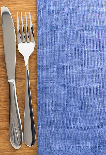 istock knife and fork at napkin on wood 498114599