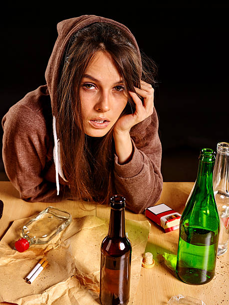istock Drunk girl holding bottle of vodka 498115112