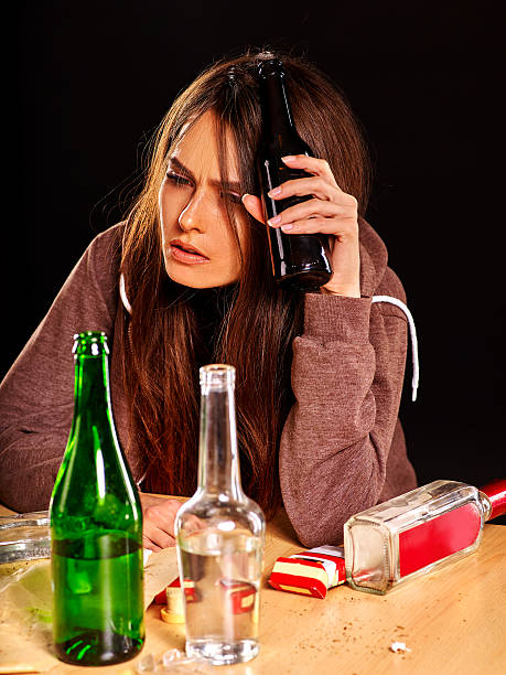 istock Drunk girl holding bottle of vodka 498115166
