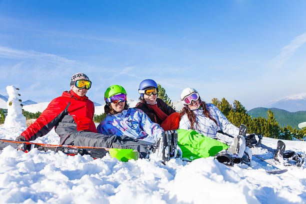 istock Four happy smiling friends wearing goggles 498115441