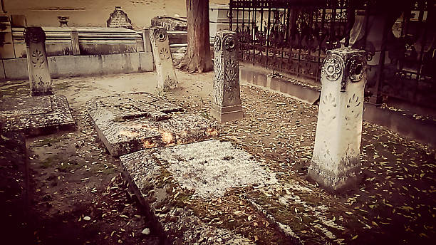 istock ANCIENT GRAVES AT CEMETERY IN AUTUMN MORNING 498115796