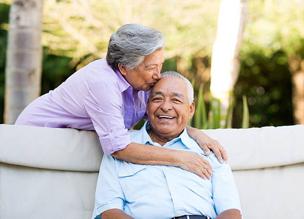 istock Mexican wife kissing husband 498115821