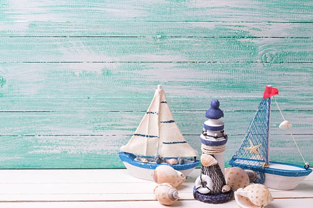 istock Decorative sailing ship and marine items on wooden background. 498117394
