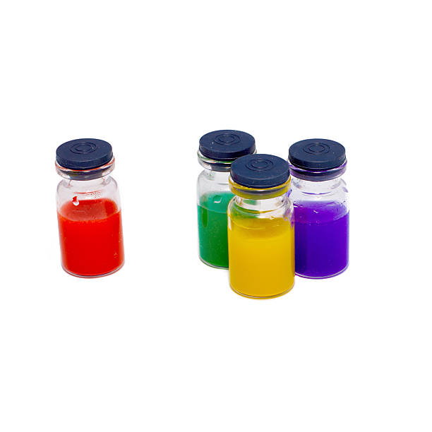 istock Four of pharmacy bottles with colored fluid 498117534