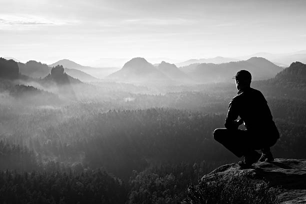 istock Runner in sportswear in squatting position  enjoy mountain scenery 498119530