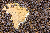 Map of Brazil under a background of coffee beans