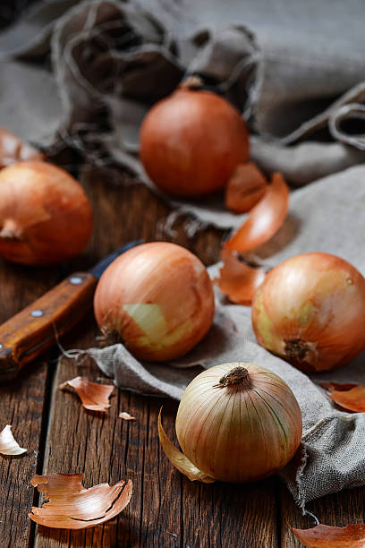 istock Raw onions on wooden background 498122816