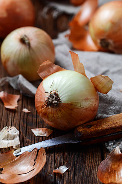 istock Raw onions on wooden background 498122960