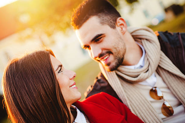istock Young happy couple on a bench at the park 498123192