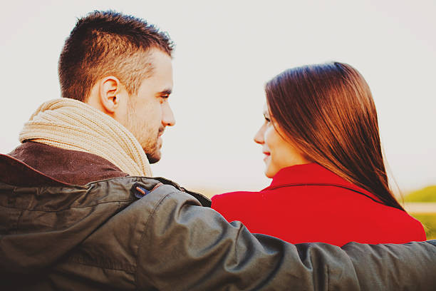 istock Young happy couple on a bench at the park 498123644