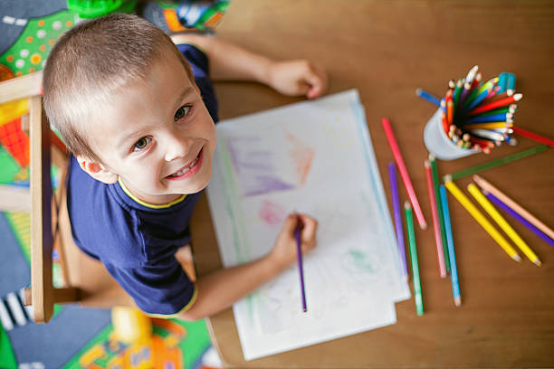 Boy, drawing a picture for mum and dad