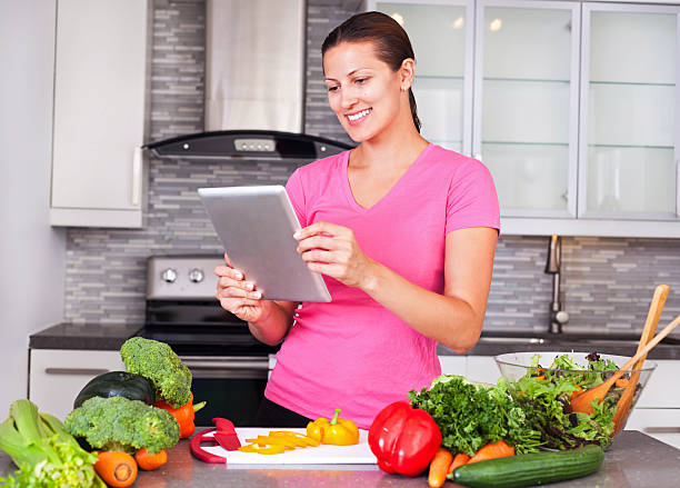istock Young woman looking for a recipe online 498125560
