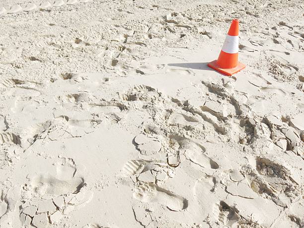 white sand background with a traffic cone stock photo