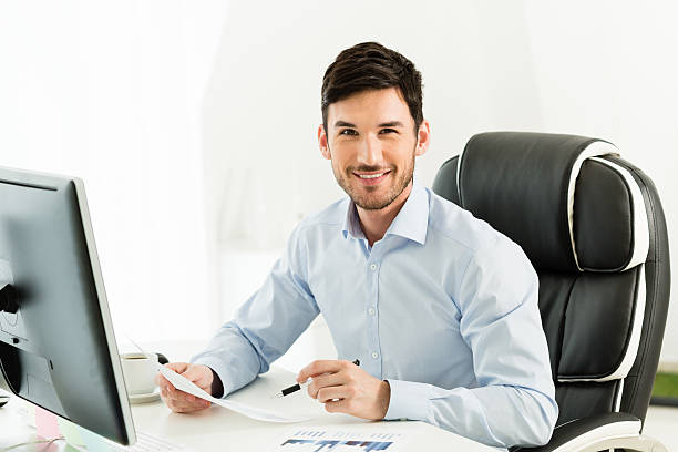 istock Smiling businessman in his office 498126601