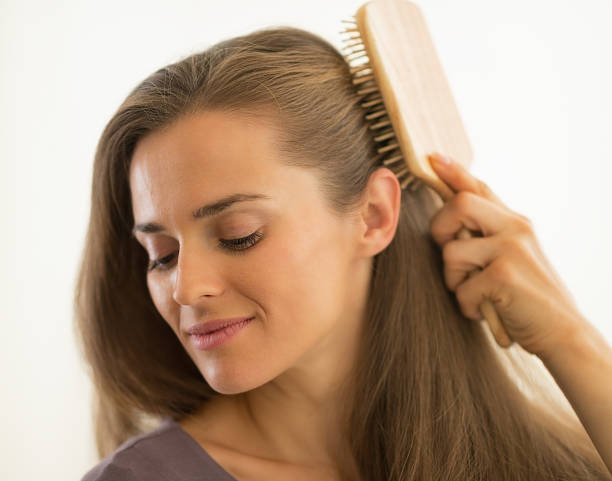 istock young woman combing hair 498127387