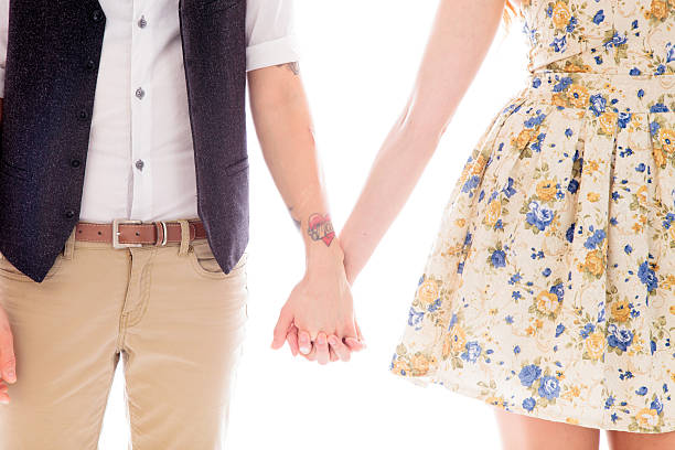 istock Lesbian couple standing together and holding hands 498129597