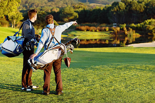 istock Watch out! Young golfer pointing out a water hazard 498129613