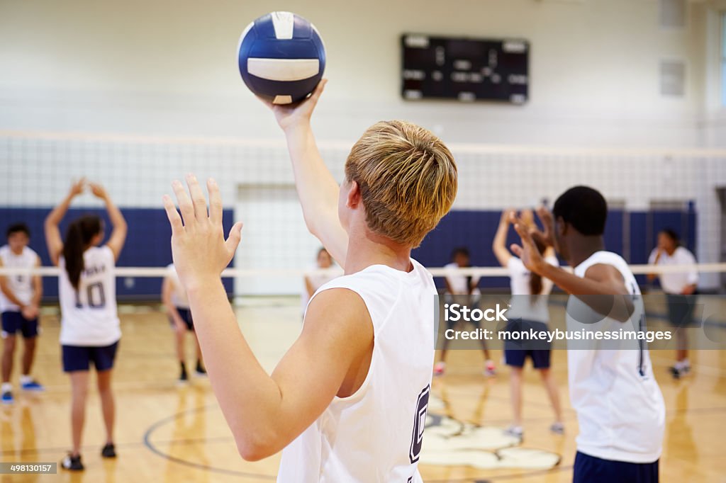 High School Volleyball Match In Gymnasium High School Volleyball Match In Gymnasium Holding Ball Volleyball - Ball Stock Photo