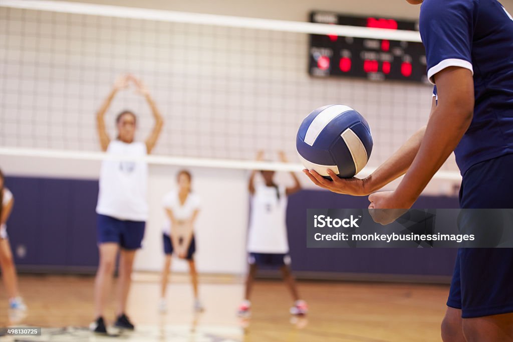 High School Volleyball Match In Gymnasium High School Volleyball Match In Gymnasium With Ball Volleyball - Sport Stock Photo