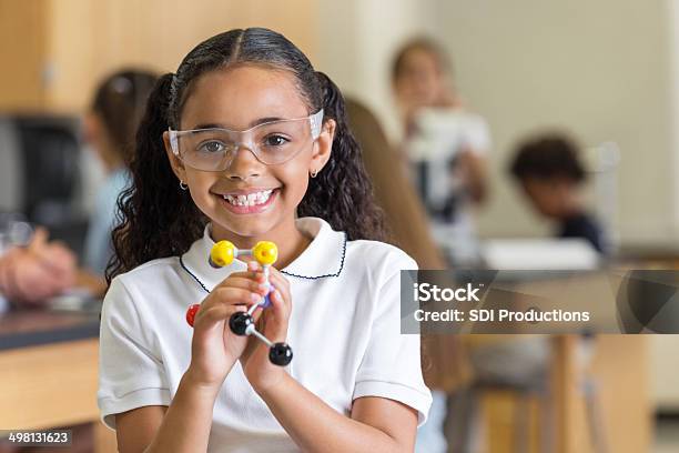 Cute Elementary School Student Learning With Atom In Science Class Stock Photo - Download Image Now