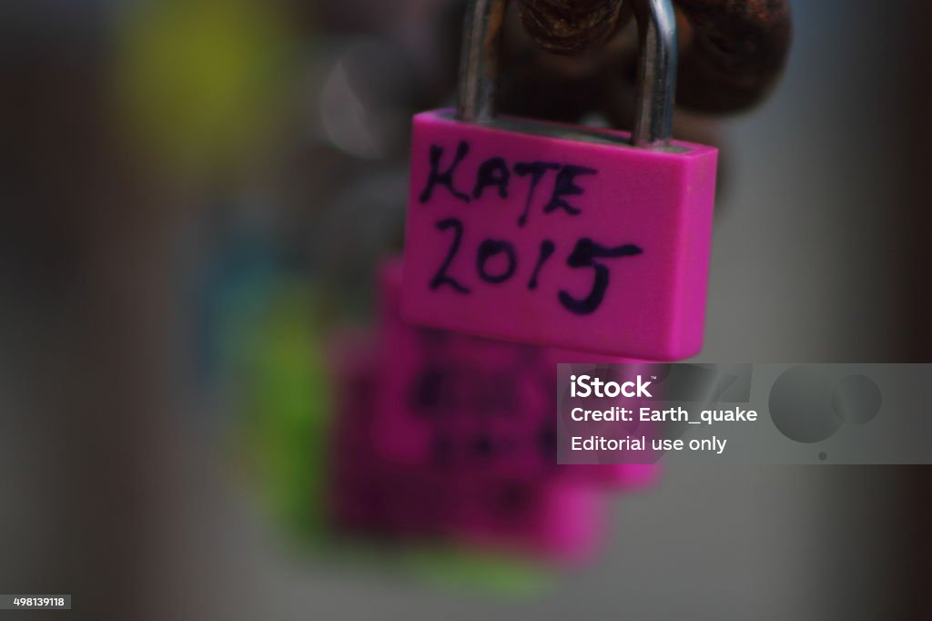 Pink padlock close up Playa Blanca, Lanzarote (Spain), September 9, 2015: Pink padlock secured to a safety chain in a popular coastal promenade in Playa Blanca. "Kate 2015,"  is one of many named padlocks. An increasing activity shared by many to remember their loved ones.  2015 Stock Photo